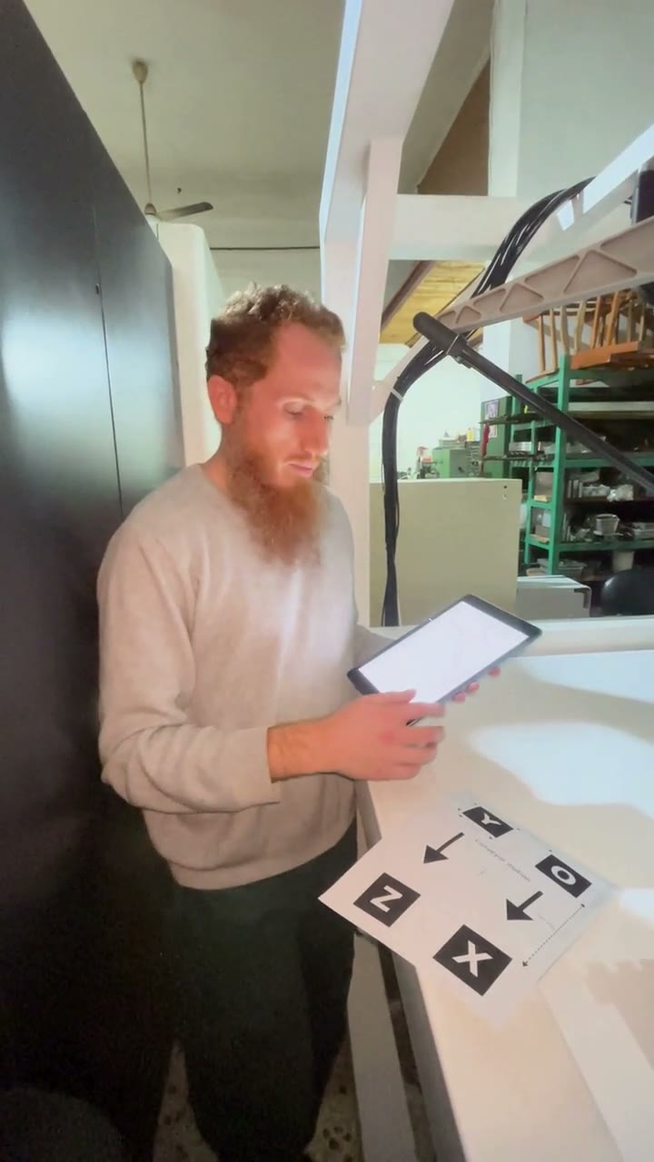 Engineer calibrating the conveyor and camera from an iPad with a calibration pattern