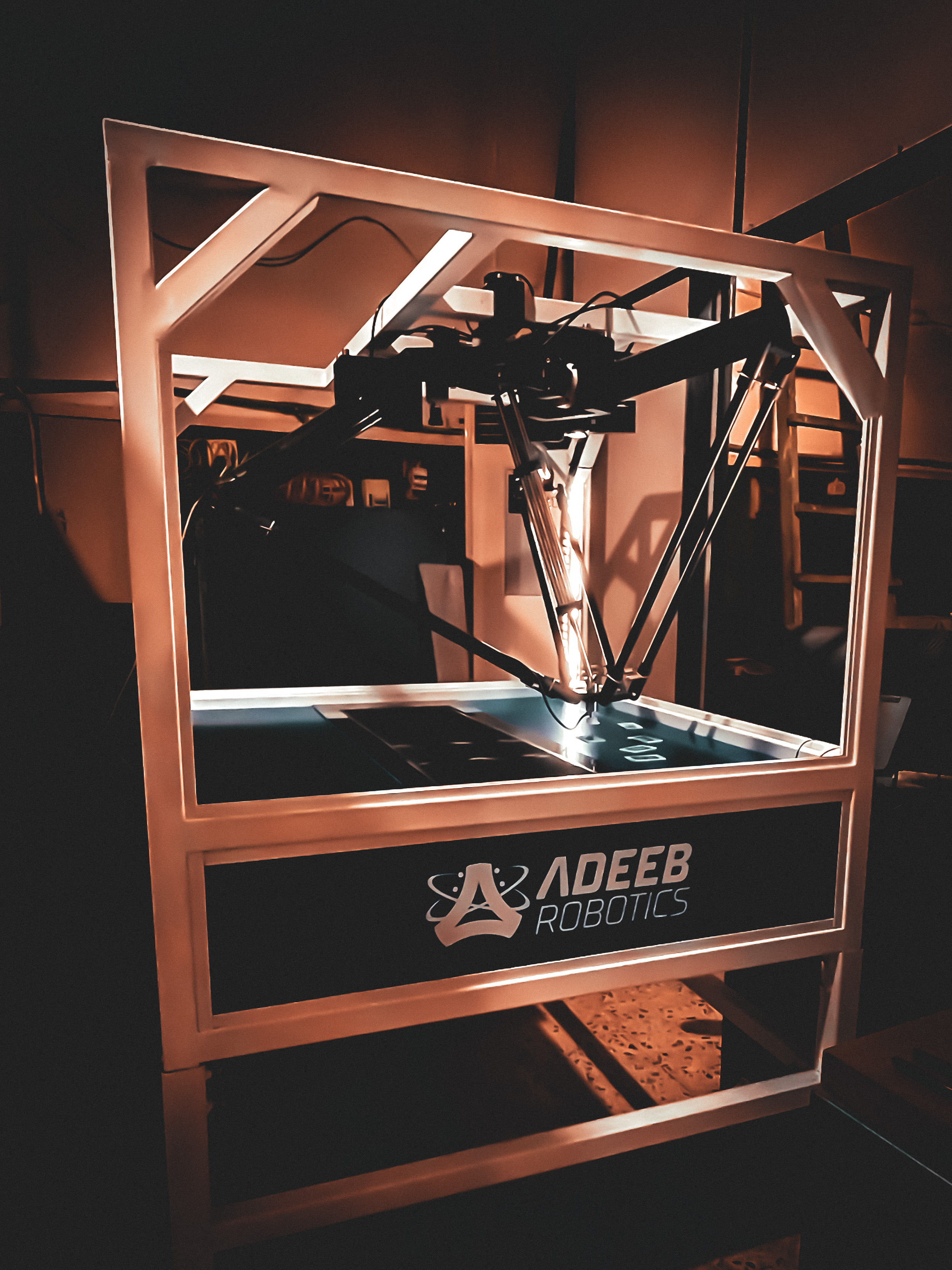 The Adeeb Delta Robot mounted in its frame above a work surface