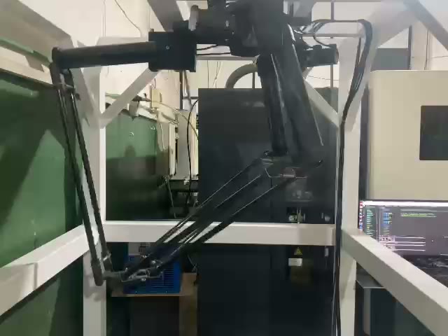 An early Adeeb delta robot prototype picking parts in the shop